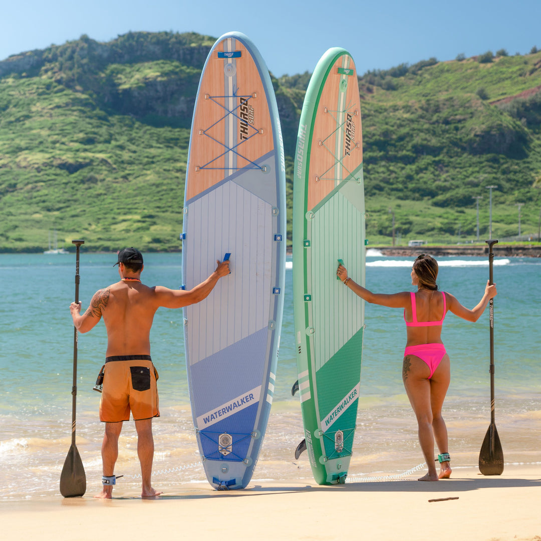 man and woman standing with waterwalker 132 dusk and waterwalker 126 turquoise psddle boards
