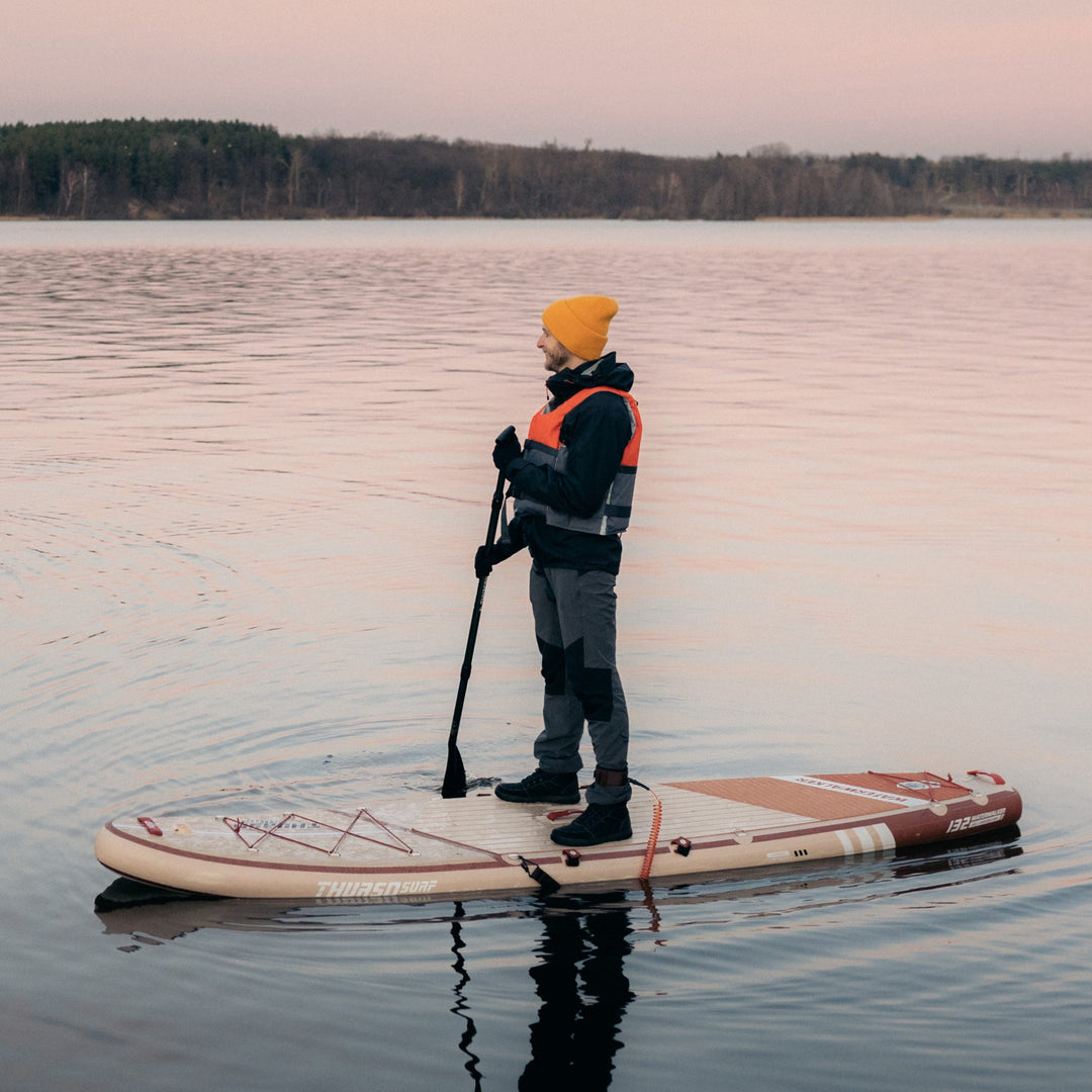 man paddling on Waterwalker 132 crimson paddle board drone shot from side