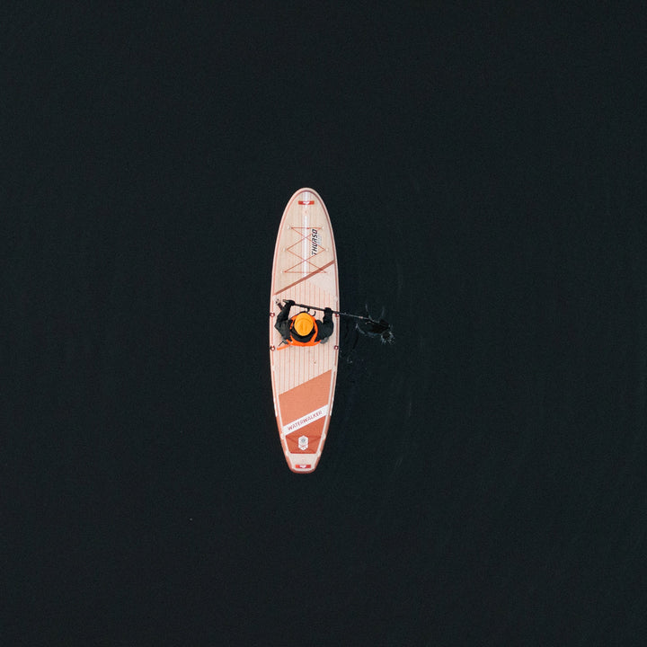 man paddling on Waterwalker 132 crimson paddle board drone shot from top
