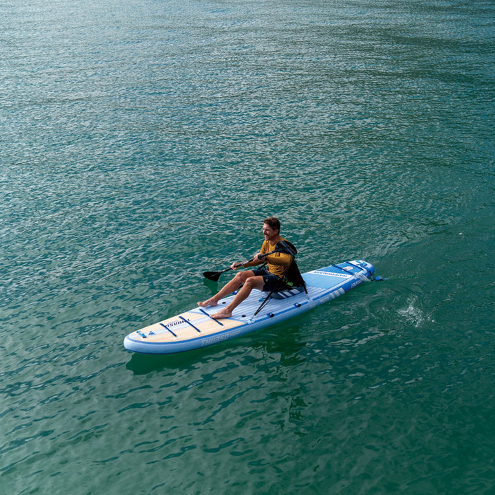 Person paddleboarding on a dusk paddleboard in clear water