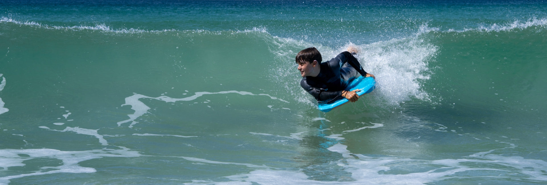 Person surfing on a wave in the ocean