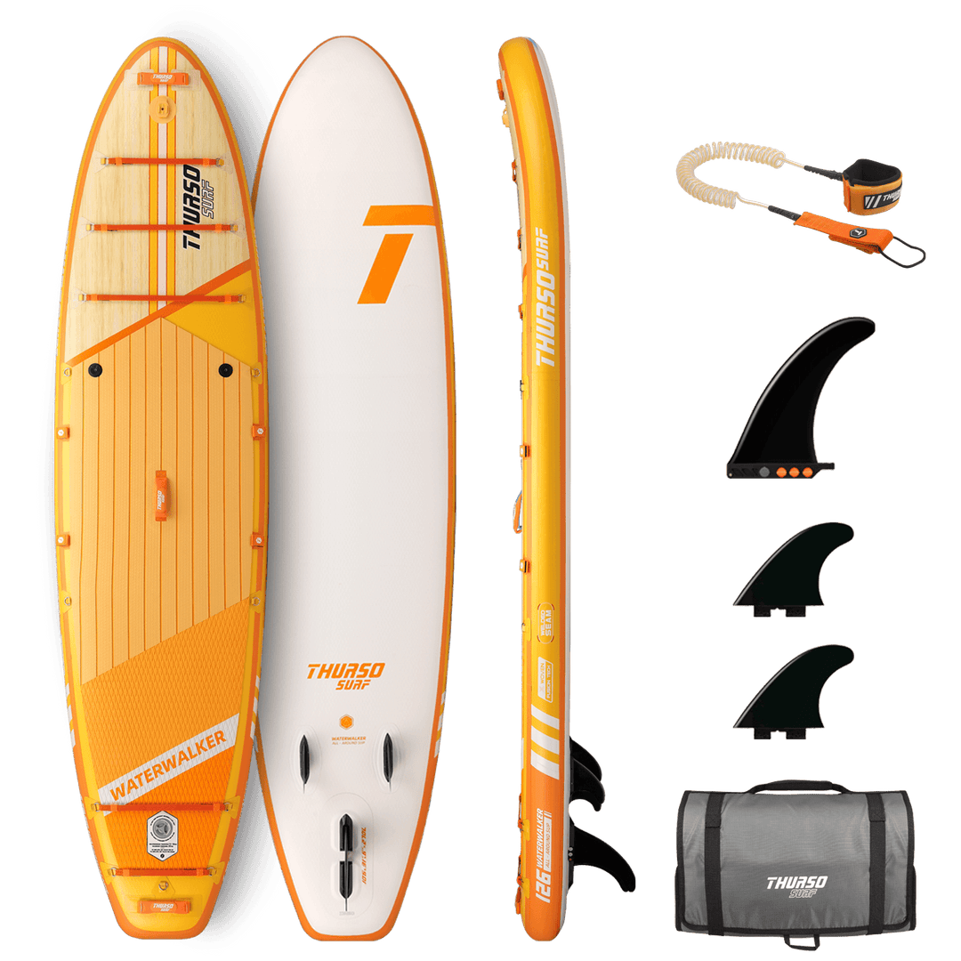 Orange and white paddleboard with accessories on a black background