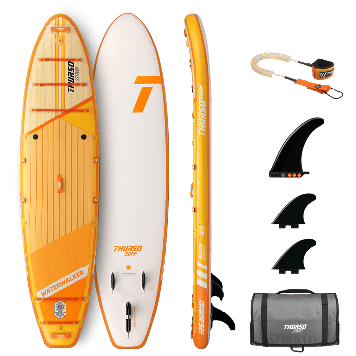 Orange and white paddleboard with accessories on a black background