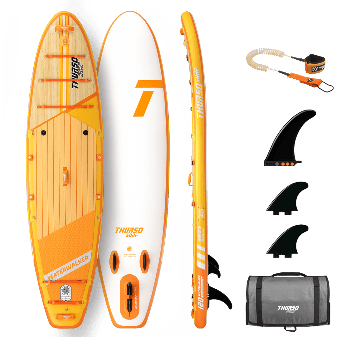 Orange and white stand-up paddleboard with accessories on a black background