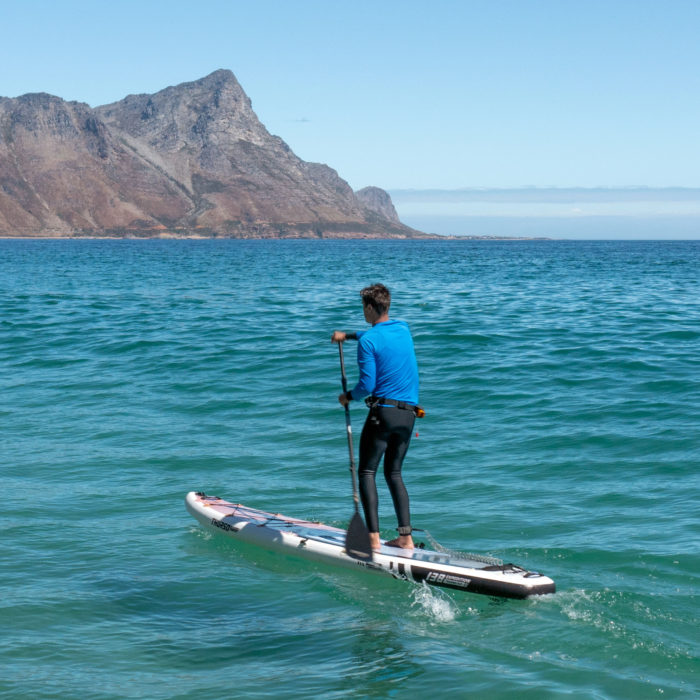 touring sup board thurso surf expedition man paddling ocean
