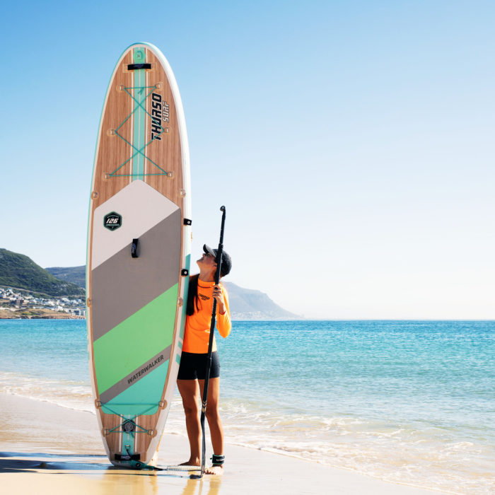 thurso surf waterwalker 126 2021 turquoise woman standing beside the board 2