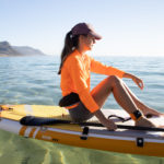 thurso surf waterwalker 132 SUP 2021 tangerine woman sitting on board